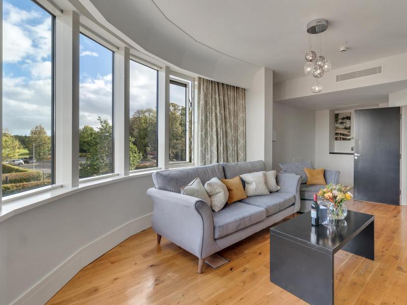 Junior suite living space image with view of window and couch