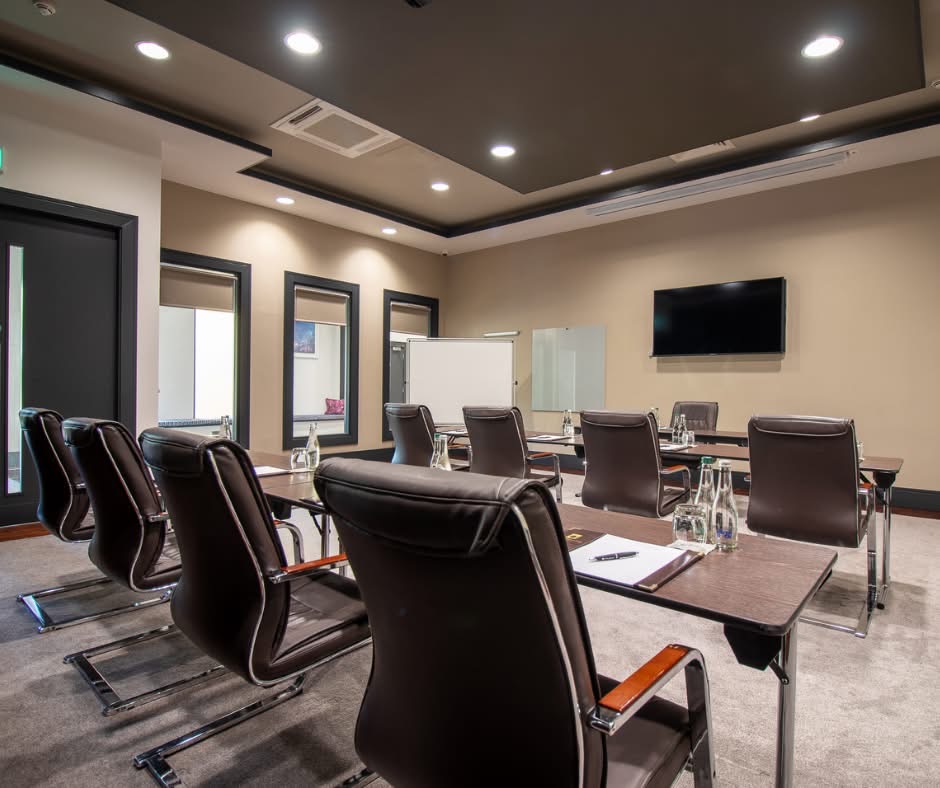 The Dorothy Suite set up with chairs and tables facing the tv