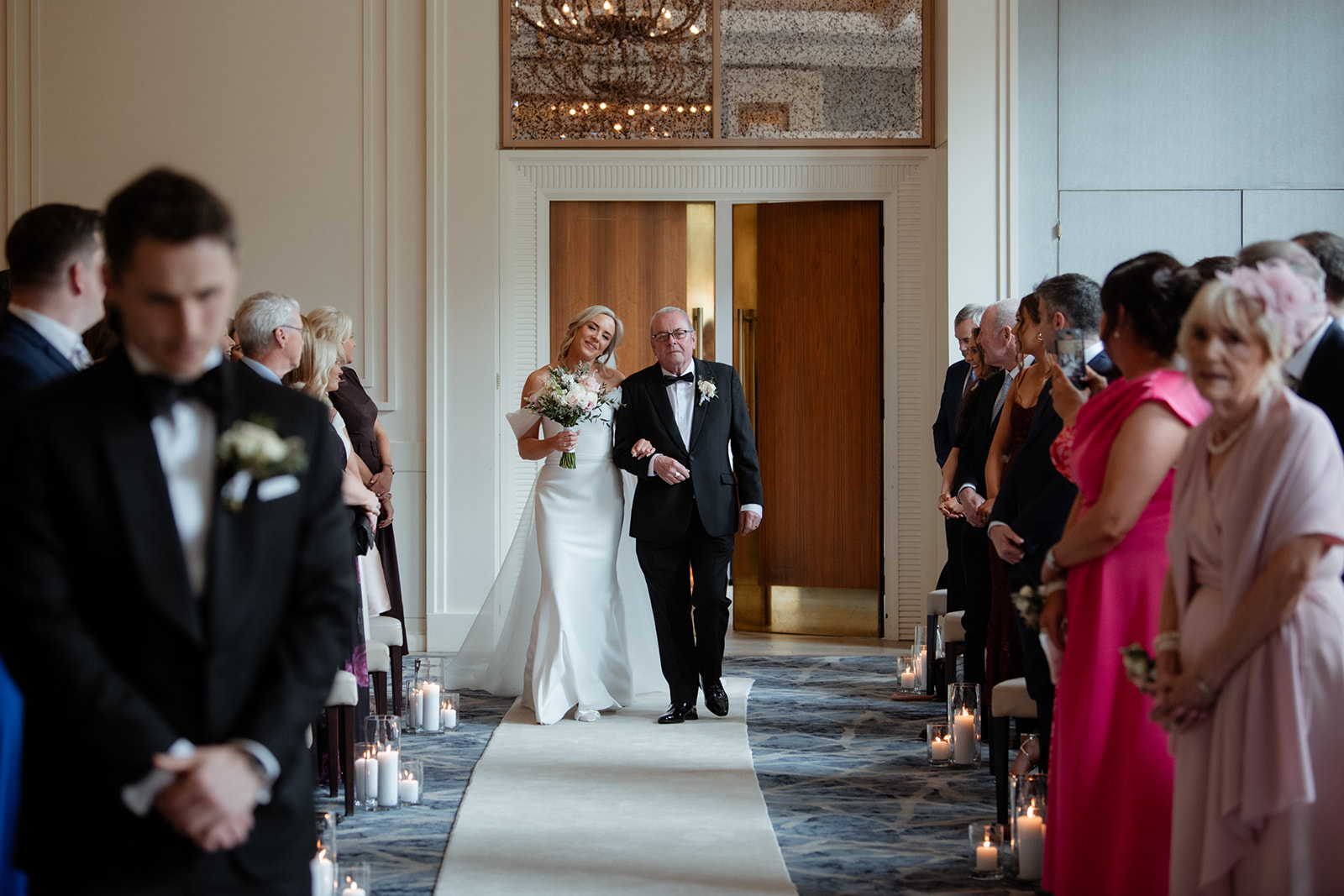 Father of the bride and the bride walking down the aisle in the smith Barry ballroom