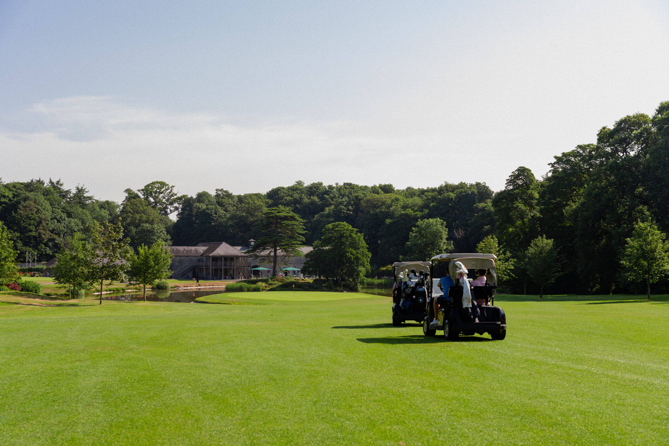 Two golf buggies travelling down the fairway on the 18th hole at Fota Island Resort