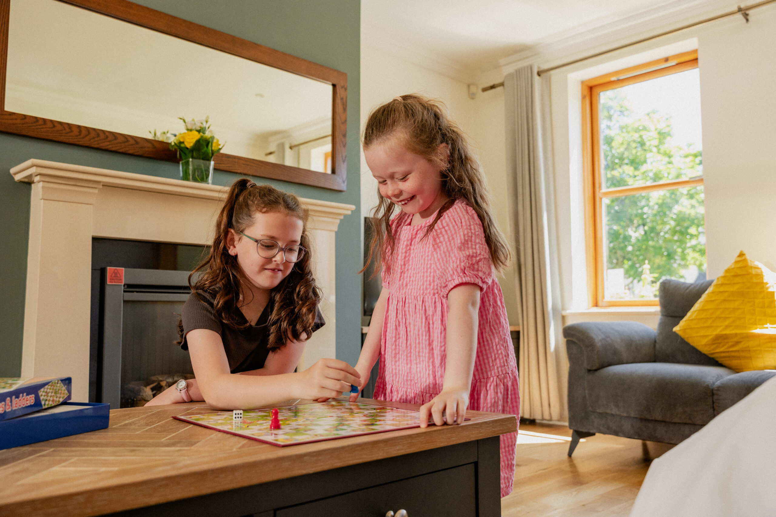 Children playing board games up close in the living area of self catering lodges