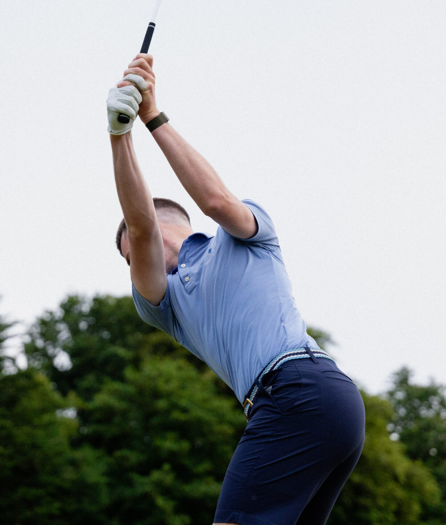 Golfer backswing shot from the ground looking up