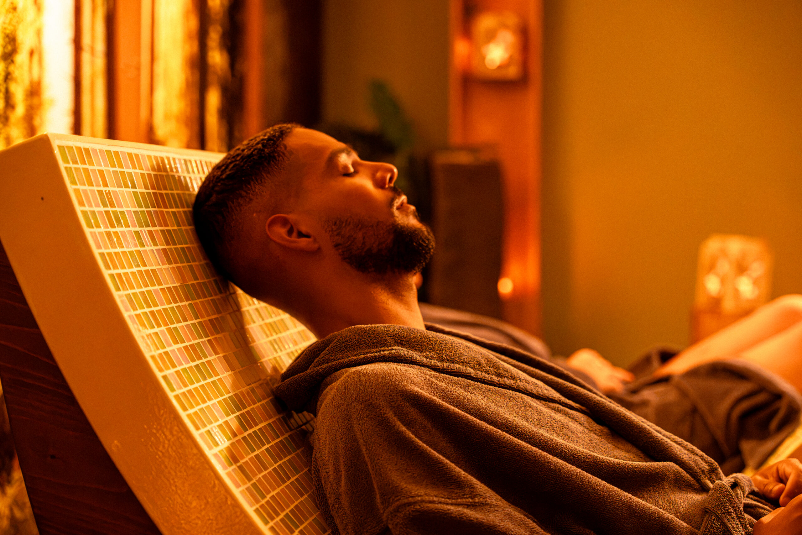 Man relaxing on heated loungers in Thermal suite