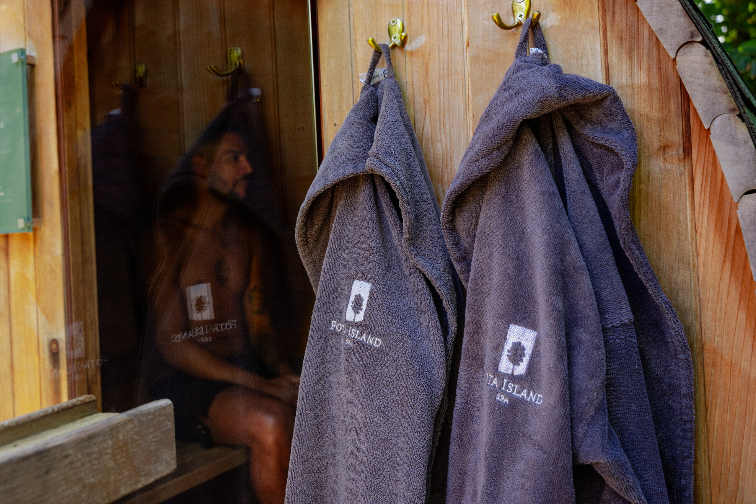 Spa robes handing outside the outdoor sauna