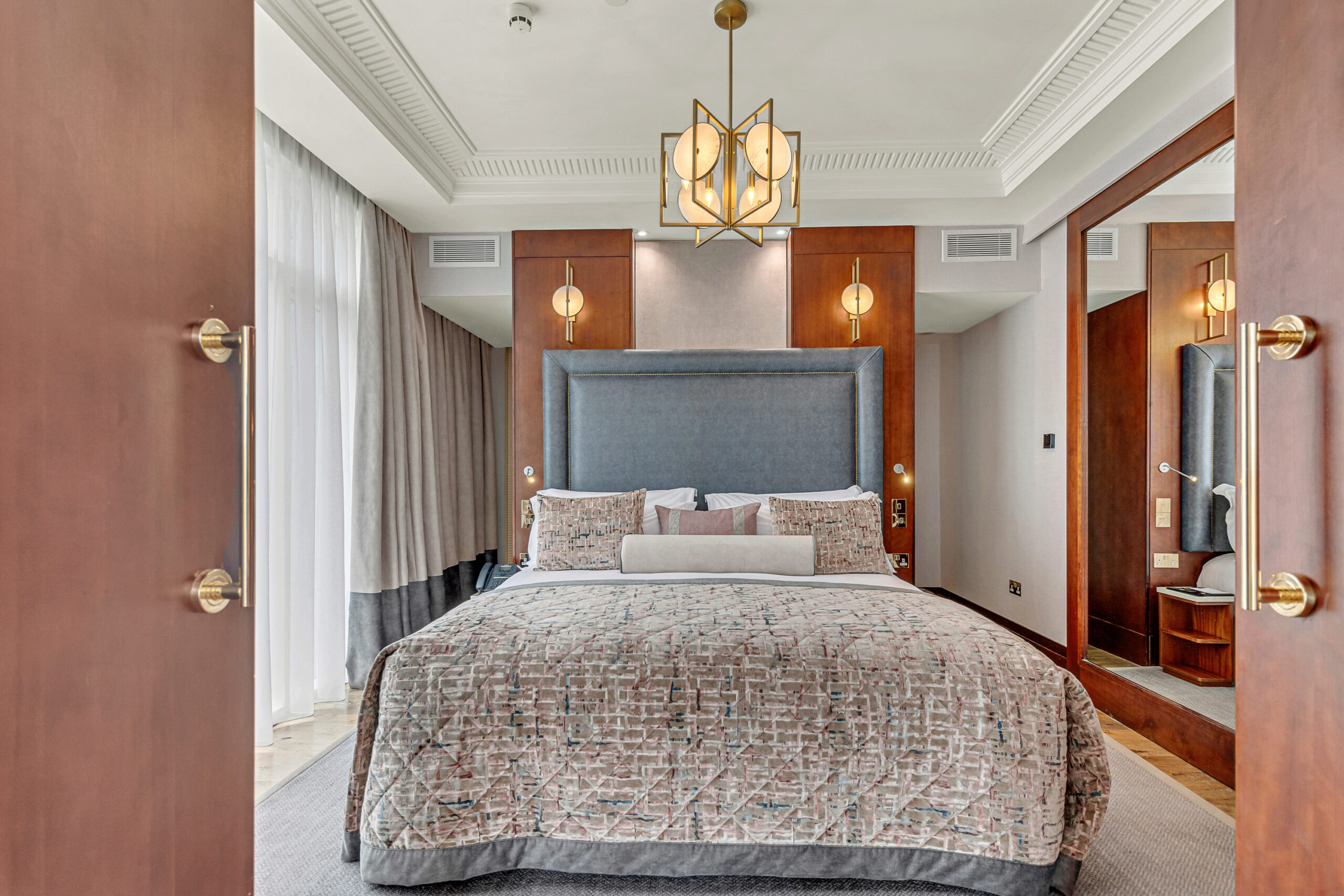 Luxury suite image shot through the bedroom doors of bed