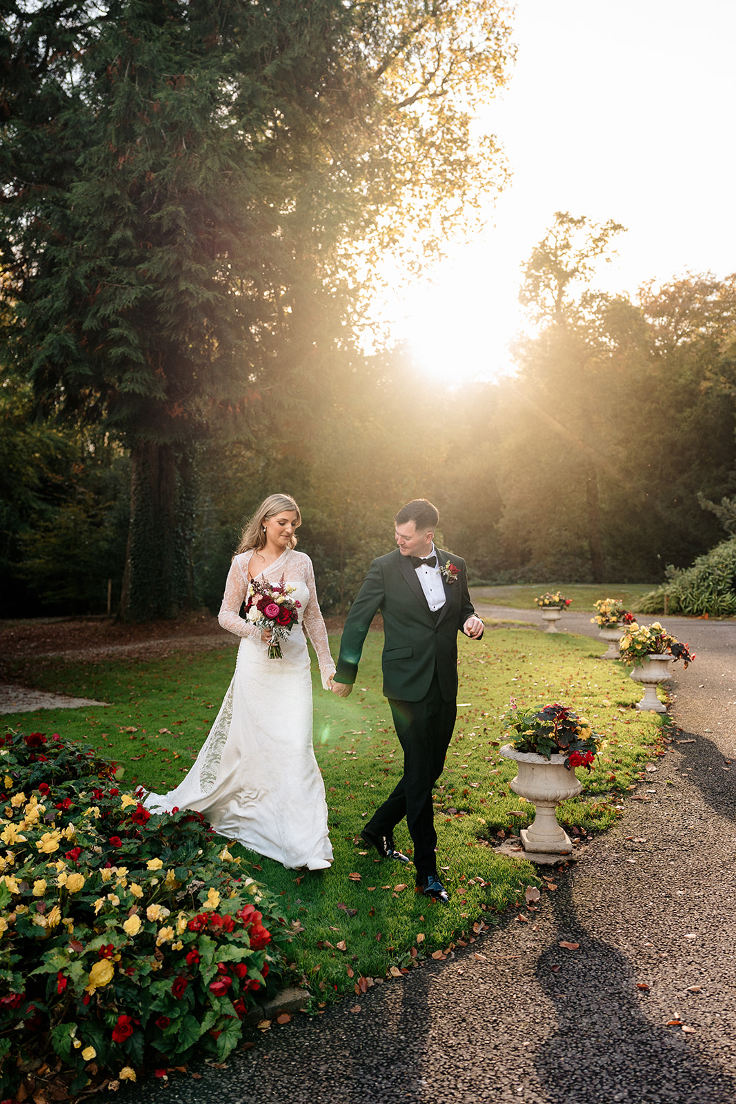 Wedding couple walking away from Gardeners lodge at golden hour