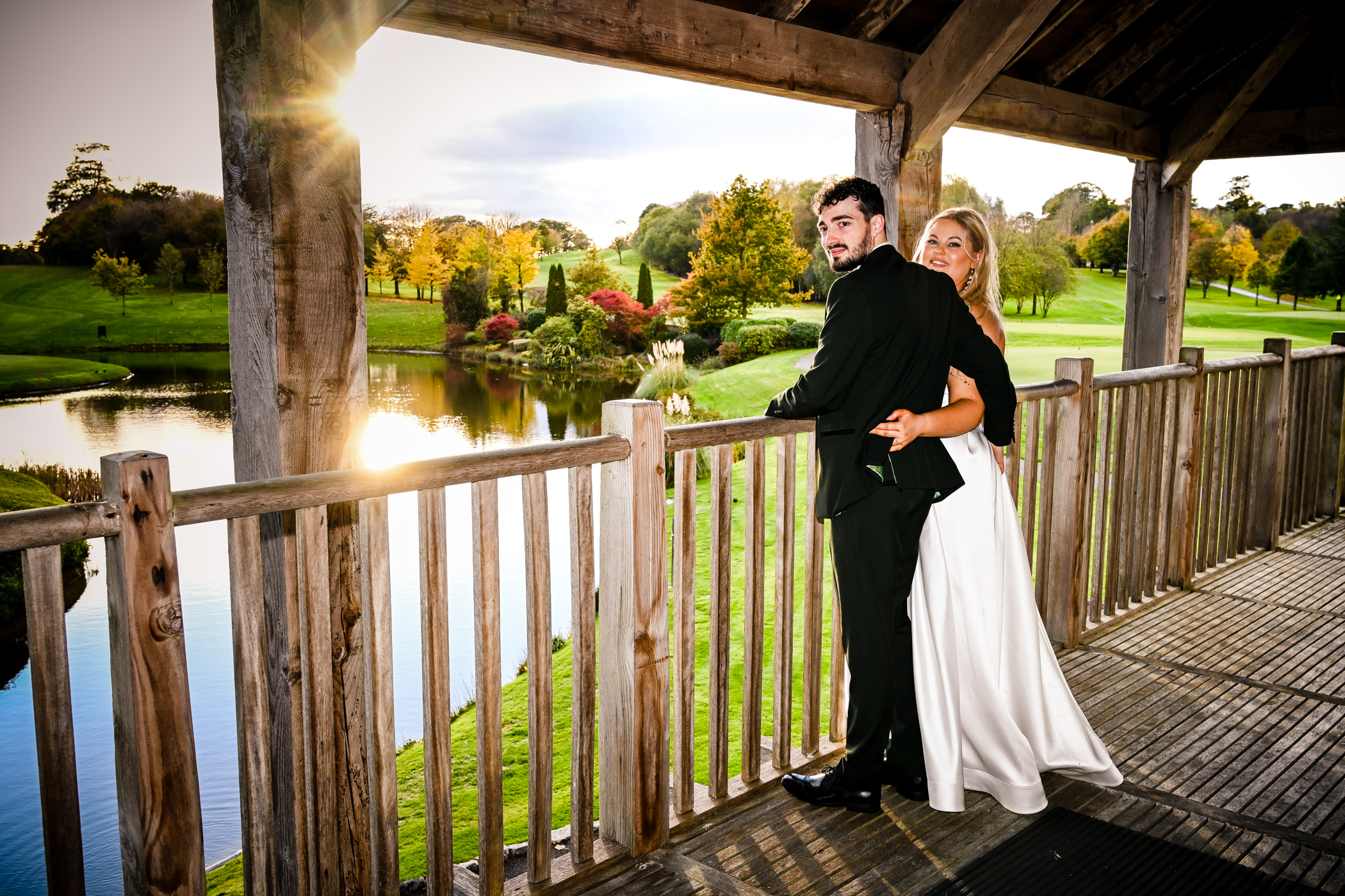 Wedding couple on the clubhouse balcony overlooking the golf course