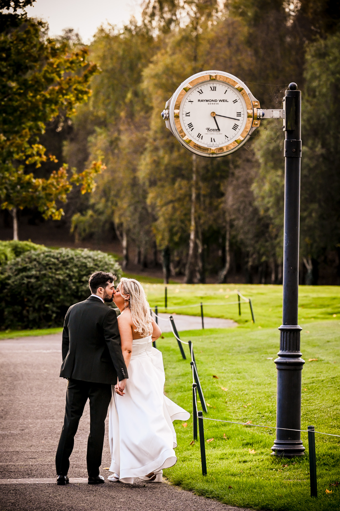 Wedding couple standing under the clock at The Clubhouse