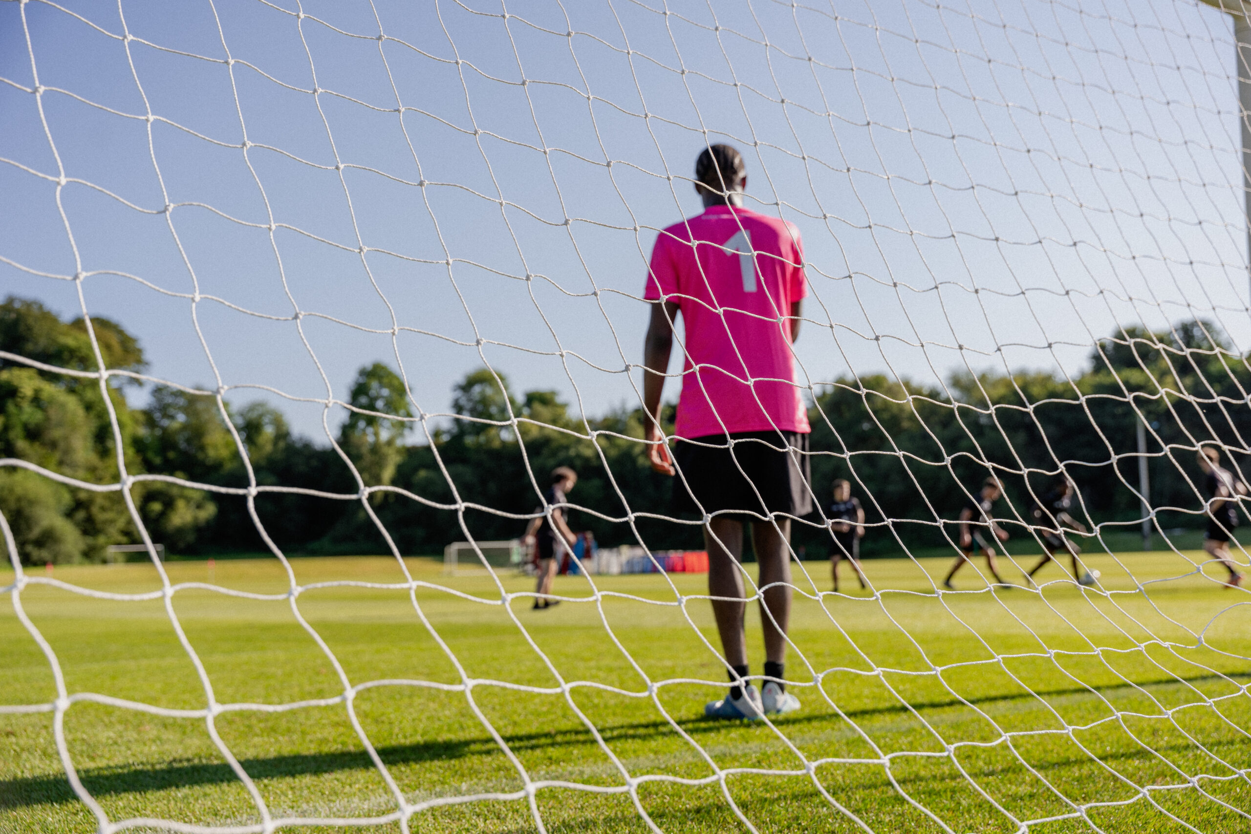 Image of goalkeeper shot through the net of the goal at the pitches In Fota Island Resort