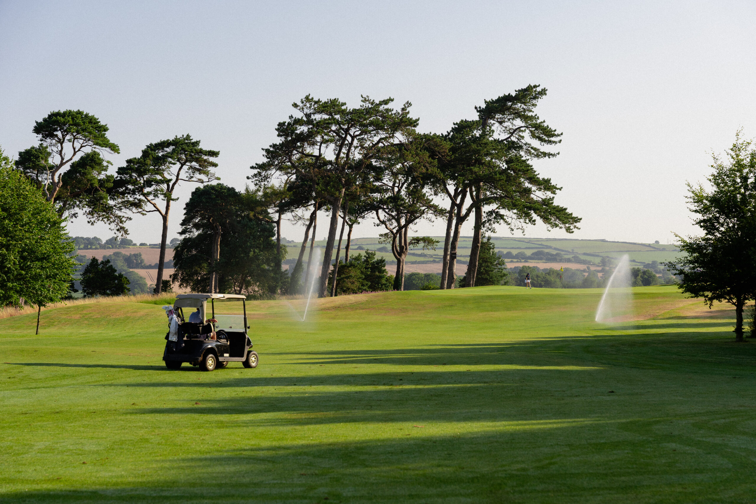 Buggy parked on fairway with sprinklers in the background at Fota Island Resort
