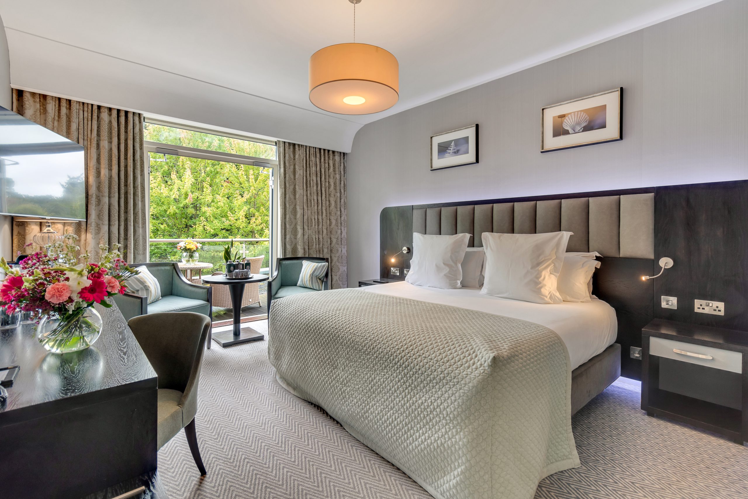 Deluxe Bedroom image with balcony and doors open
